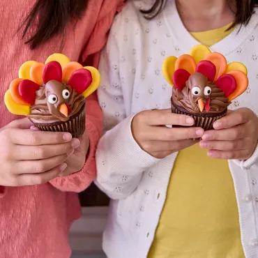 Two children holding Turkey Cupcakes